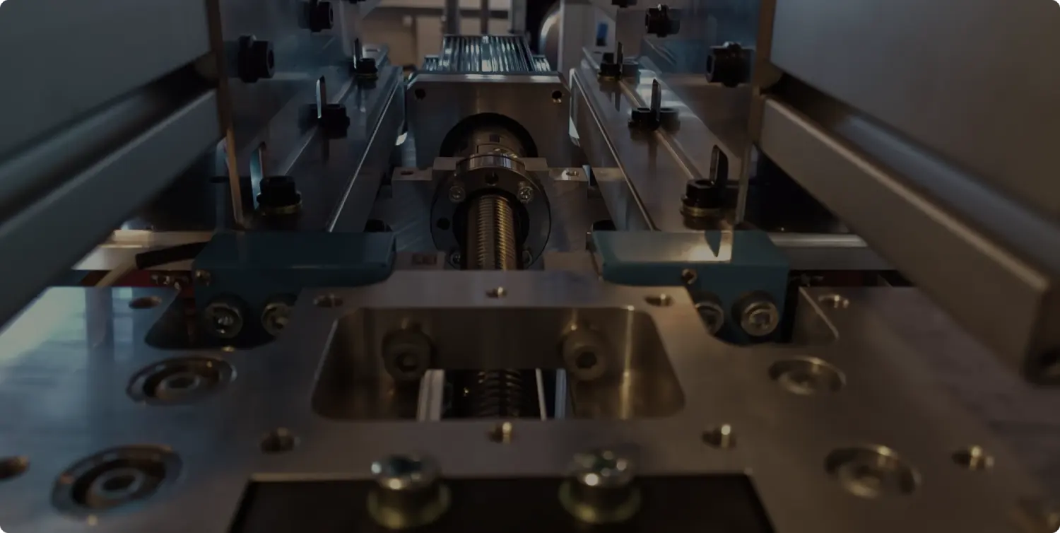 Looking along a linear axis at the ball screw nut, the carriage and the proximity switches