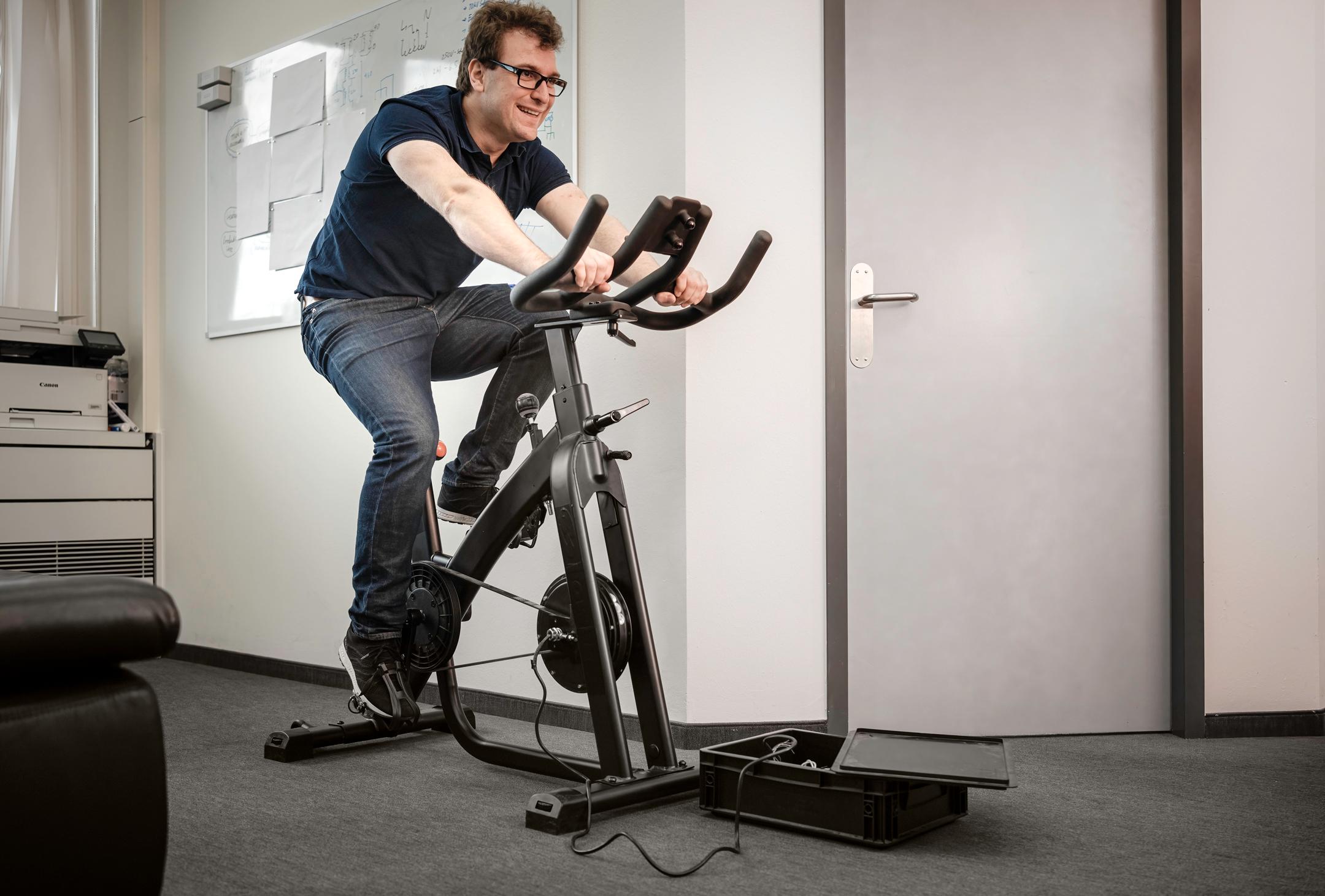 Sebastian on the spinning bike in the office